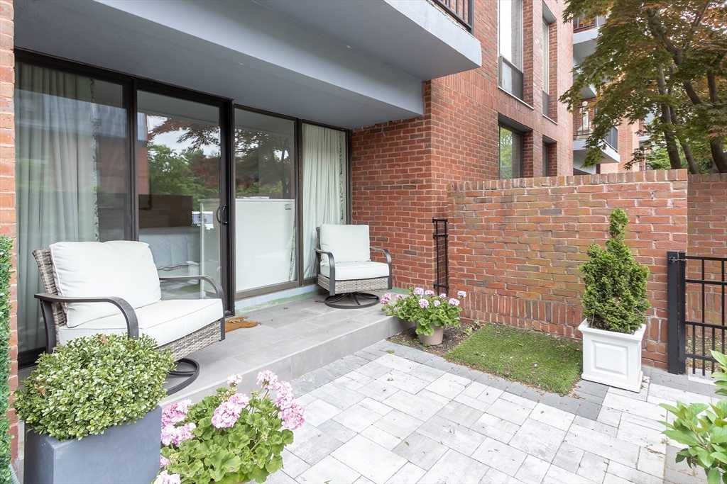 75 Grove Street, Unit 132 Wellesley, MA 02482 - Photo 17 of 20 a front view of a house with garden