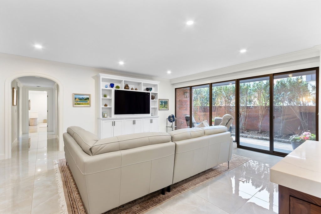 75 Grove Street, Unit 132 Wellesley, MA 02482 - Photo 5 of 20 a living room with furniture tv and a large window