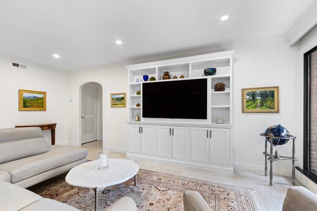 75 Grove Street, Unit 132 Wellesley, MA 02482 - Photo 7 of 20 a living room with furniture and a flat screen tv