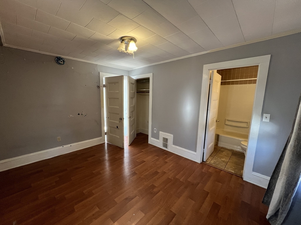 34 Chestnut Street, Unit 3 Wakefield, MA 01880 - Photo 2 of 7 a view of an empty room with wooden floor and a window
