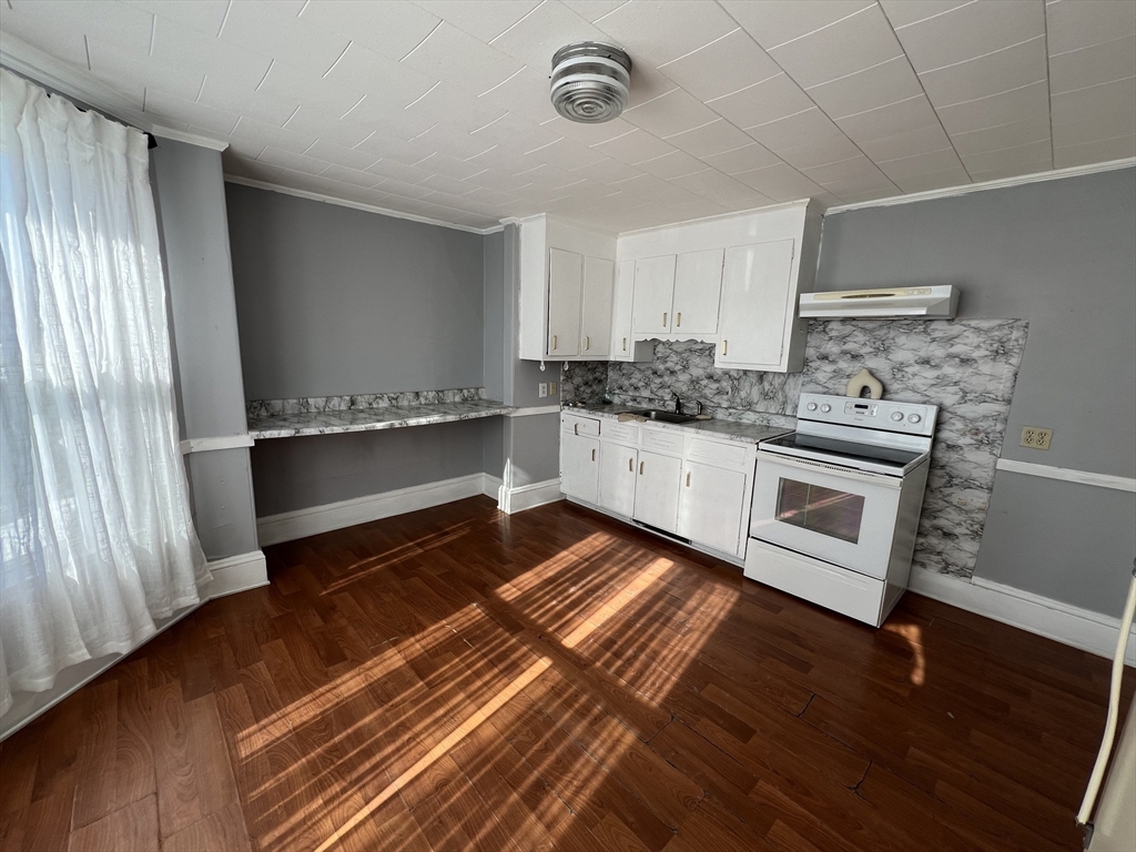 34 Chestnut Street, Unit 3 Wakefield, MA 01880 - Photo 5 of 7 a kitchen with stainless steel appliances granite countertop a stove and a refrigerator