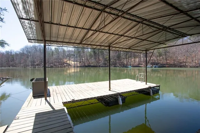 a view of a lake with couches chairs