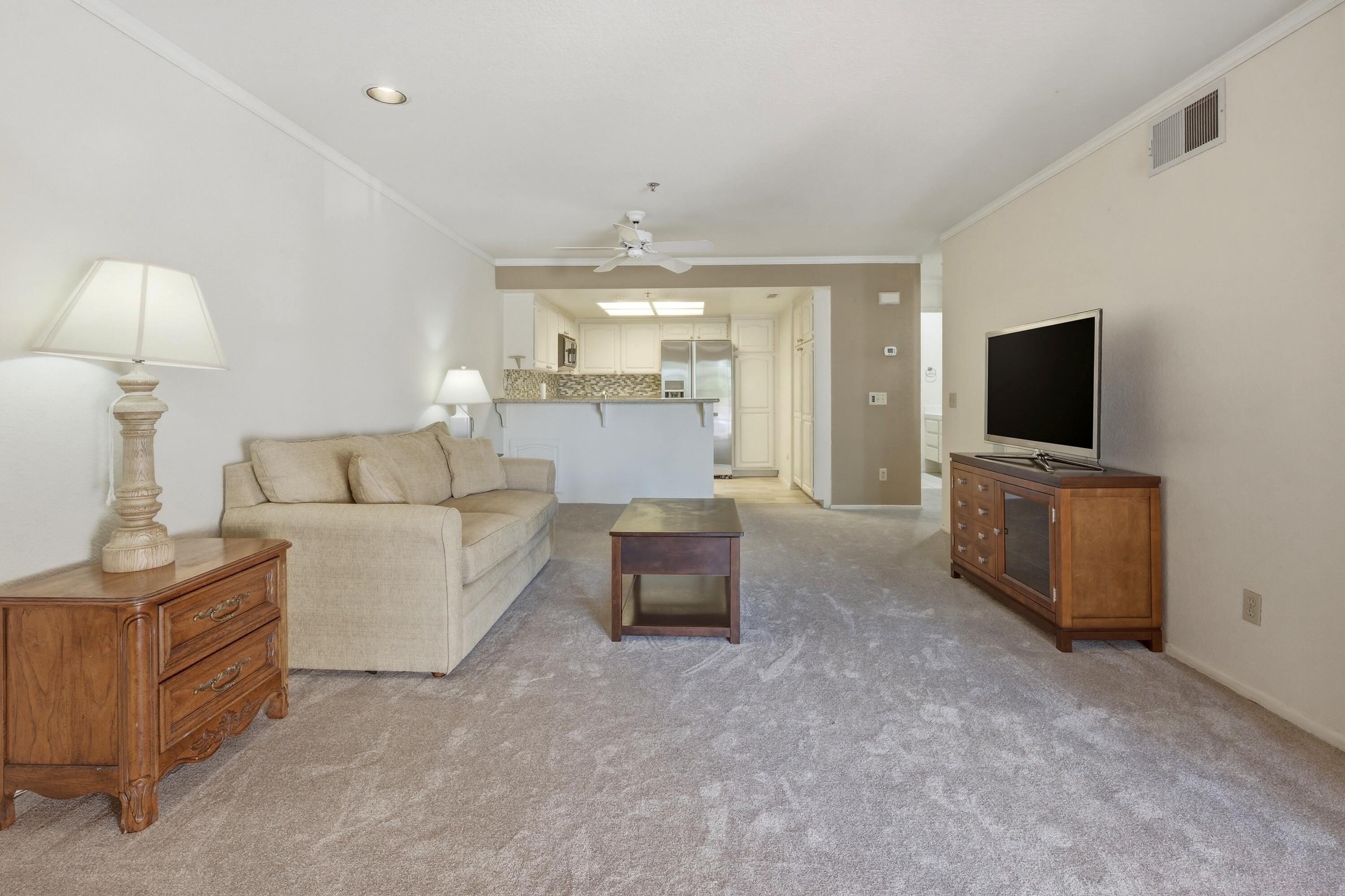 500 East Amado Road, Unit 511 Palm Springs, CA 92262 - Photo 11 of 28 a living room with furniture and a flat screen tv