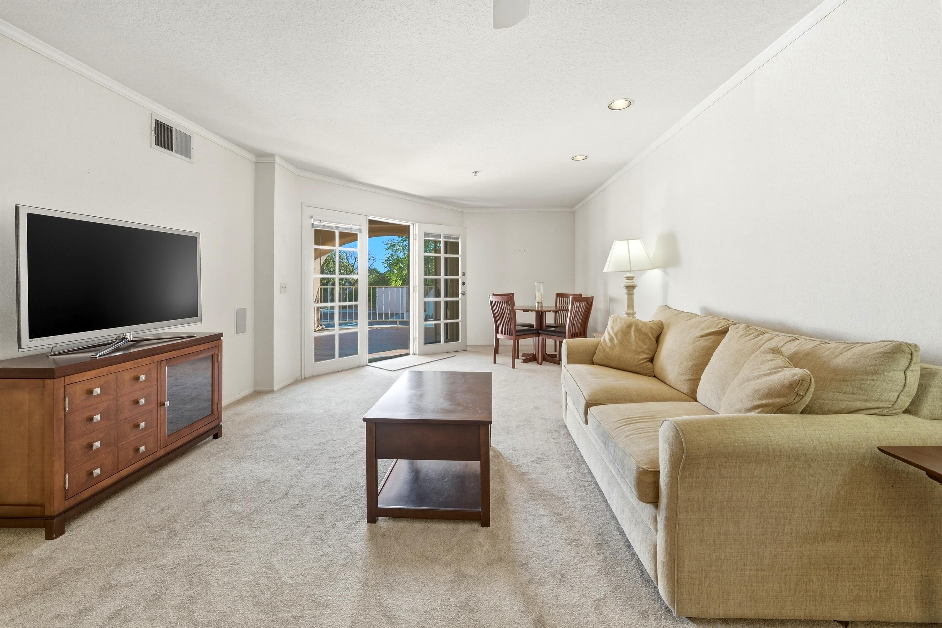 500 East Amado Road, Unit 511 Palm Springs, CA 92262 - Photo 12 of 28 a living room with furniture and a flat screen tv