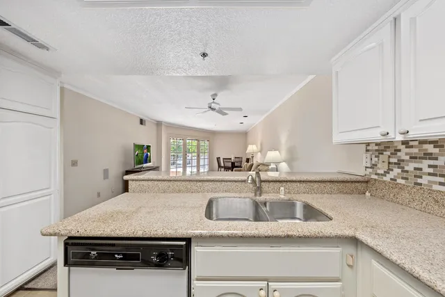 a kitchen with granite countertop a sink and a stove