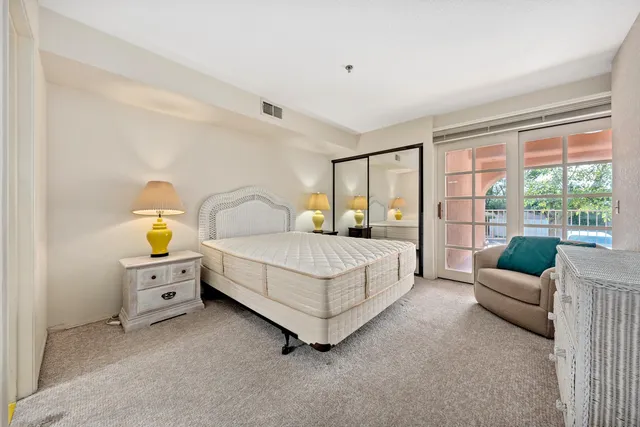 a bedroom with a bed couch and window