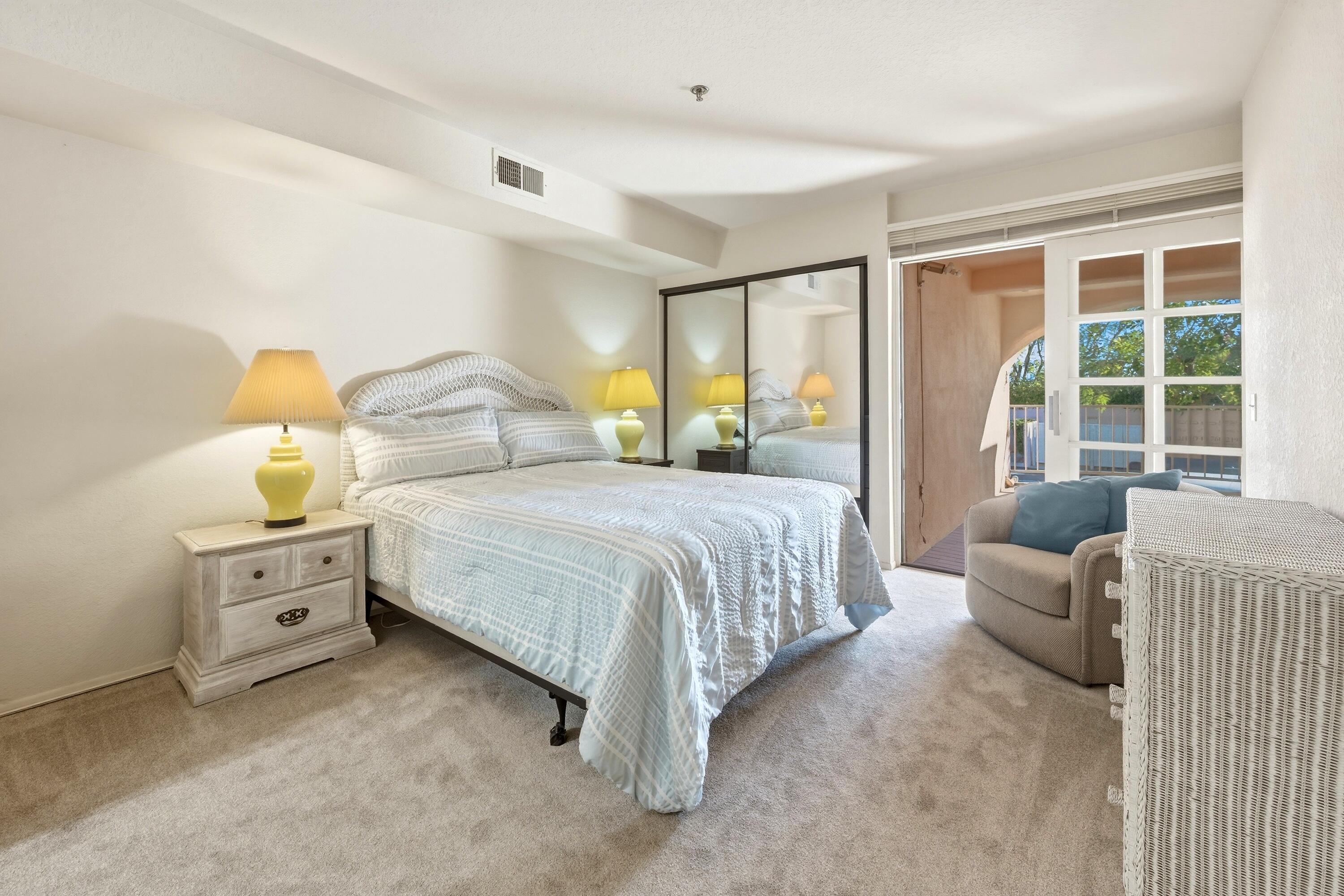 500 East Amado Road, Unit 511 Palm Springs, CA 92262 - Photo 19 of 28 a bedroom with a bed and large windows