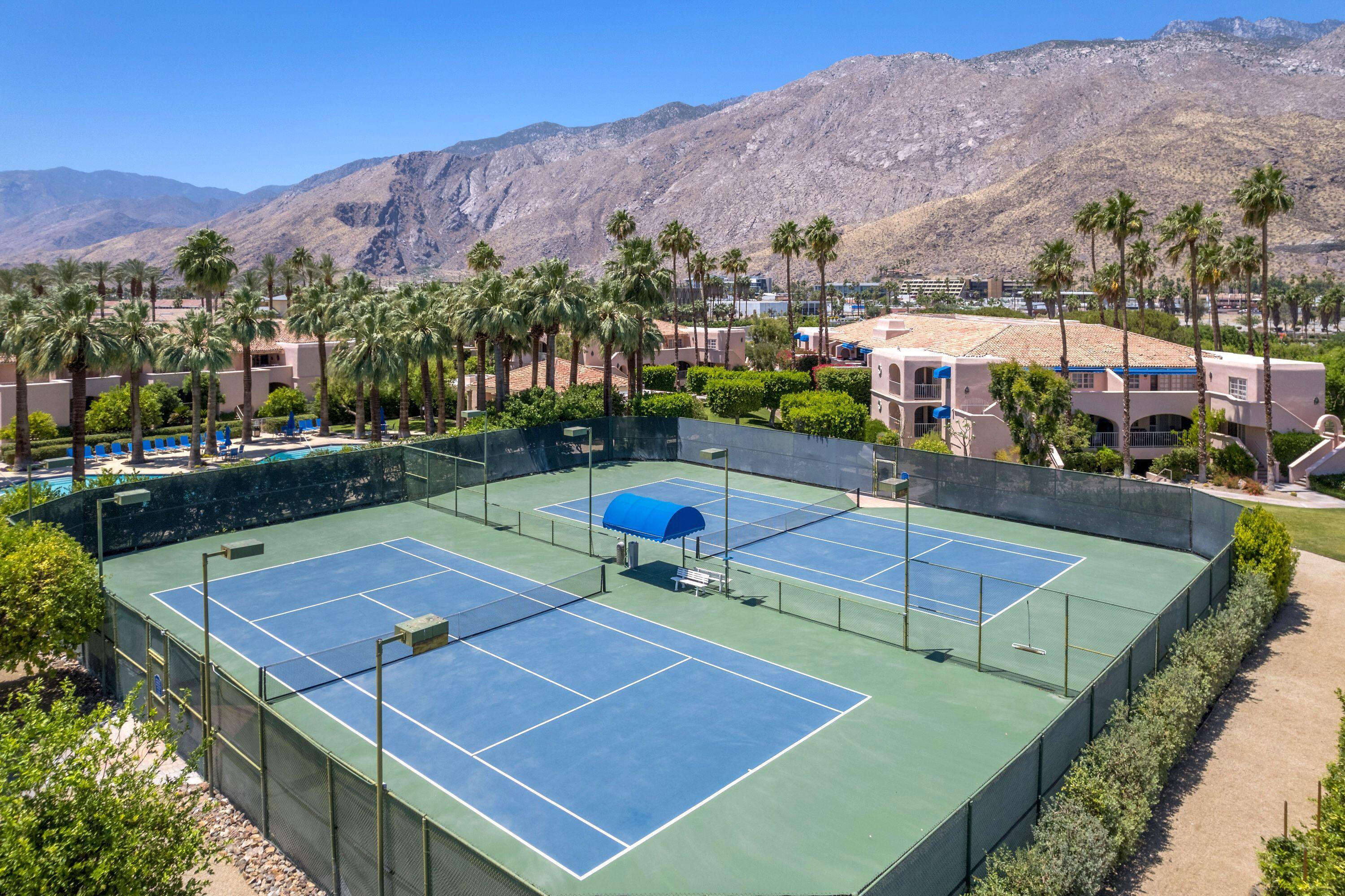 500 East Amado Road, Unit 511 Palm Springs, CA 92262 - Photo 25 of 28 an aerial view of a tennis ground and a houses