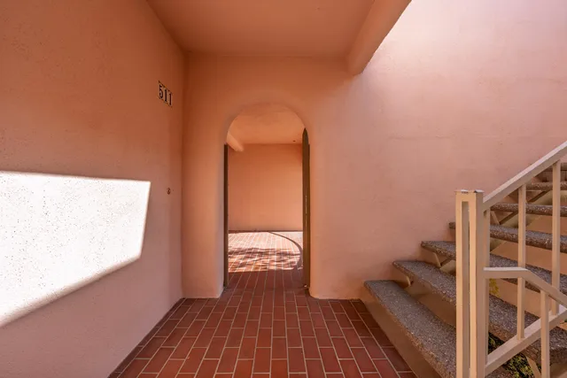 a view of a room with wooden floor and bathroom