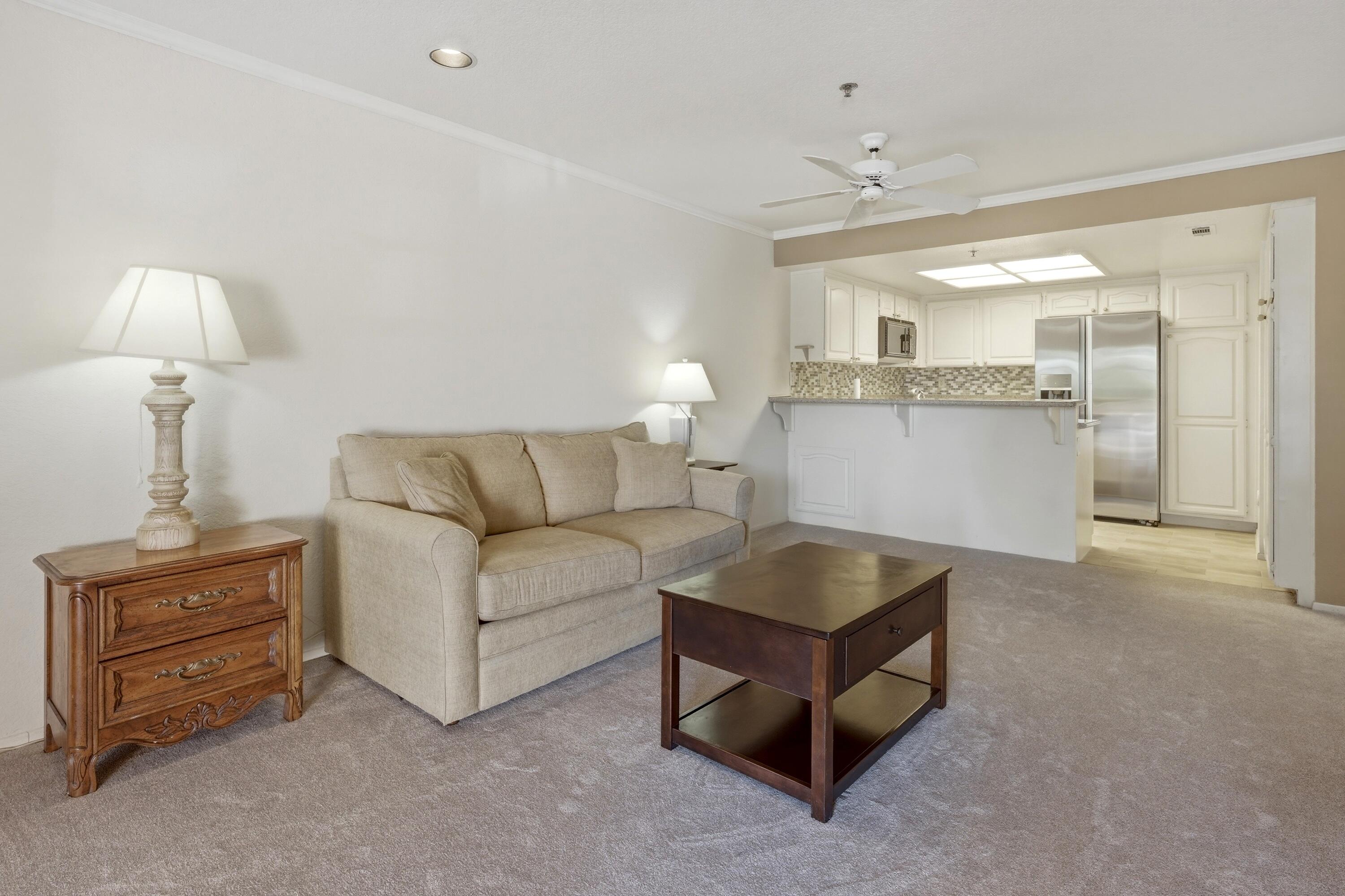 500 East Amado Road, Unit 511 Palm Springs, CA 92262 - Photo 10 of 28 a living room with furniture and a lamp