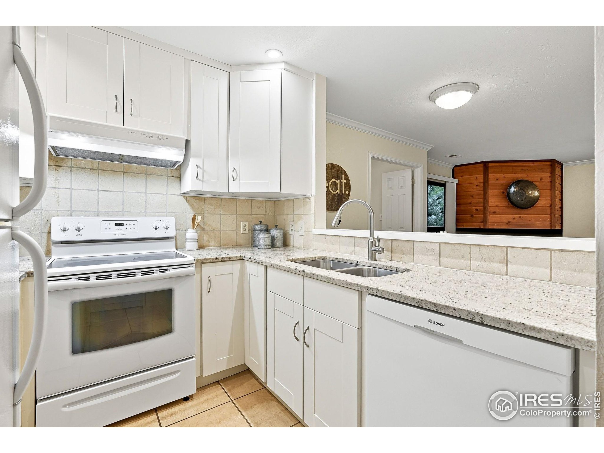 1303 Alpine Avenue, Unit 24 Boulder, CO 80304 - Photo 13 of 46 a kitchen with granite countertop white cabinets and white appliances