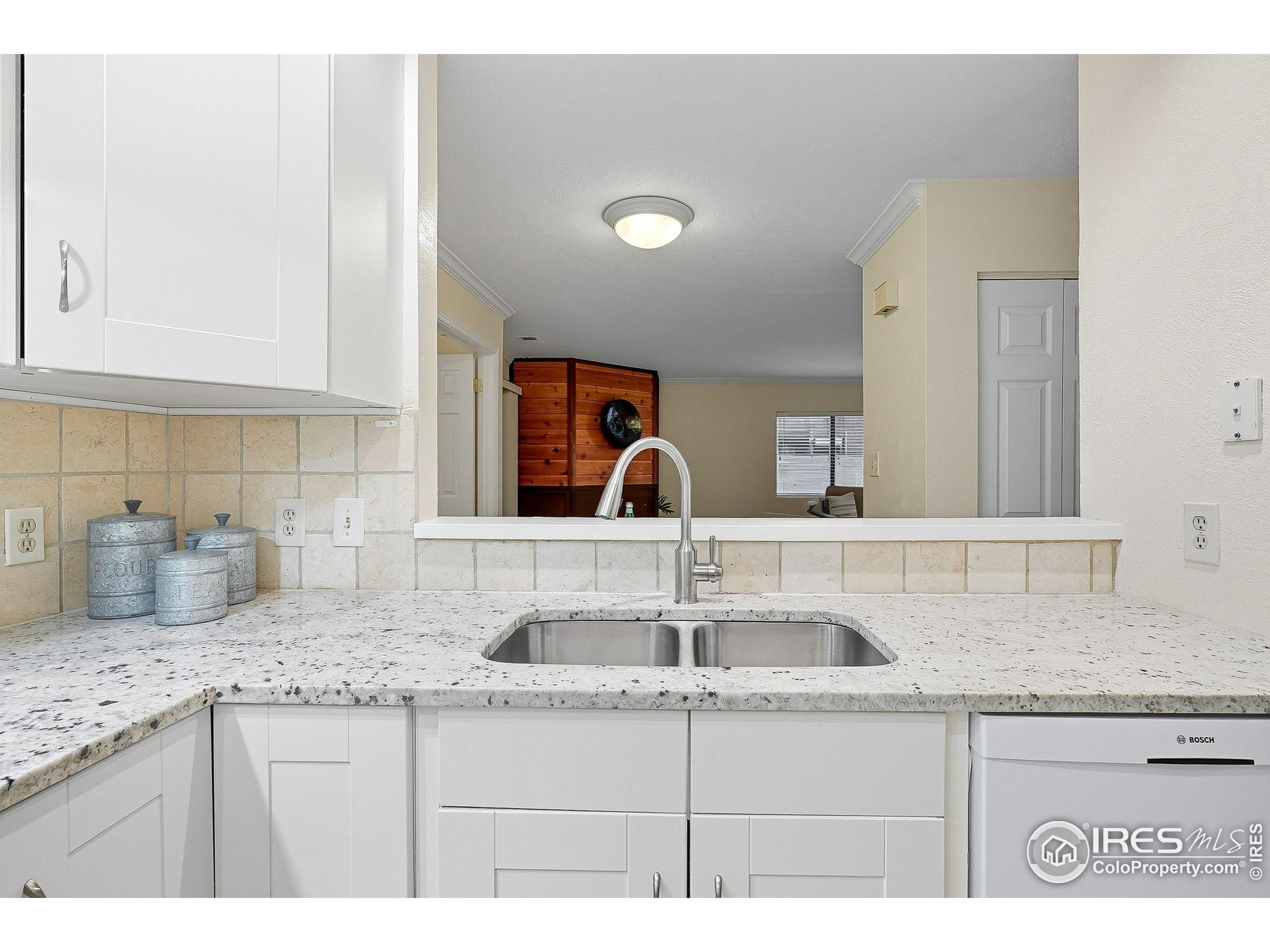 1303 Alpine Avenue, Unit 24 Boulder, CO 80304 - Photo 14 of 46 a kitchen with sink and mirror