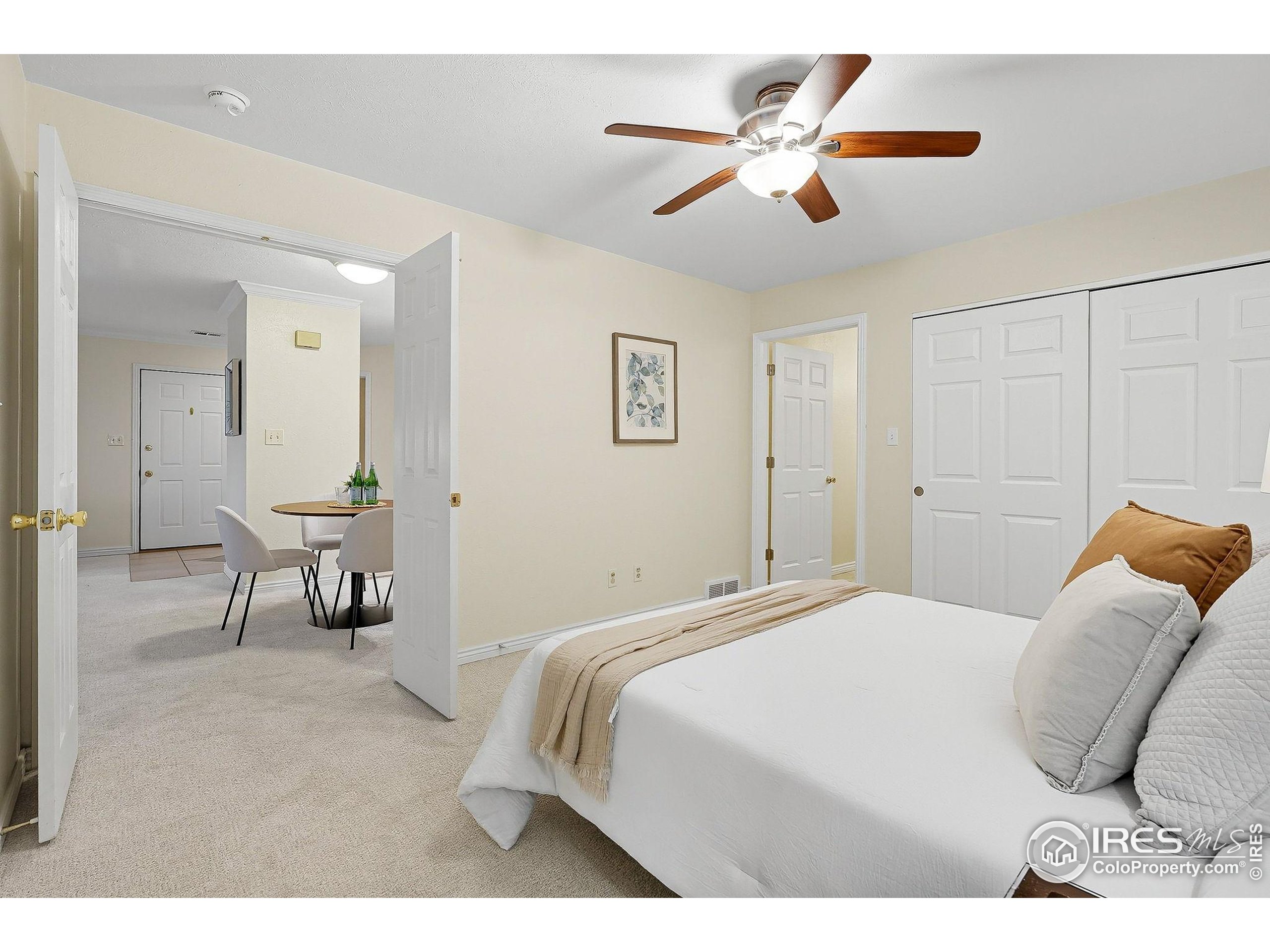 1303 Alpine Avenue, Unit 24 Boulder, CO 80304 - Photo 18 of 46 a bedroom with a bed and a chandelier