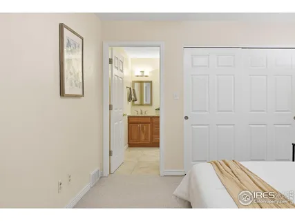 a bathroom with a granite countertop sink a mirror a toilet and shower