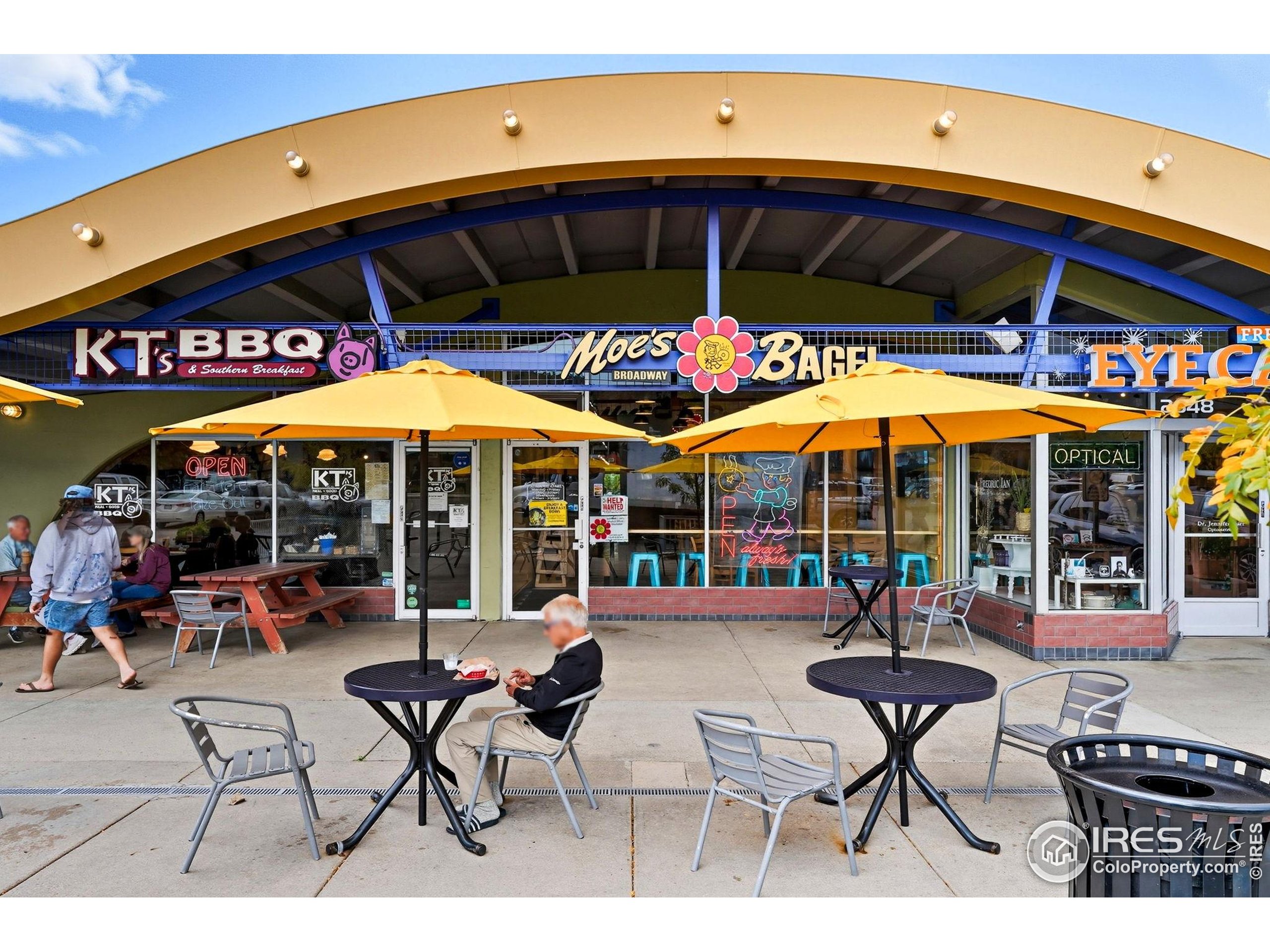 1303 Alpine Avenue, Unit 24 Boulder, CO 80304 - Photo 42 of 46 a view of a cafe with a table and chairs under an umbrella