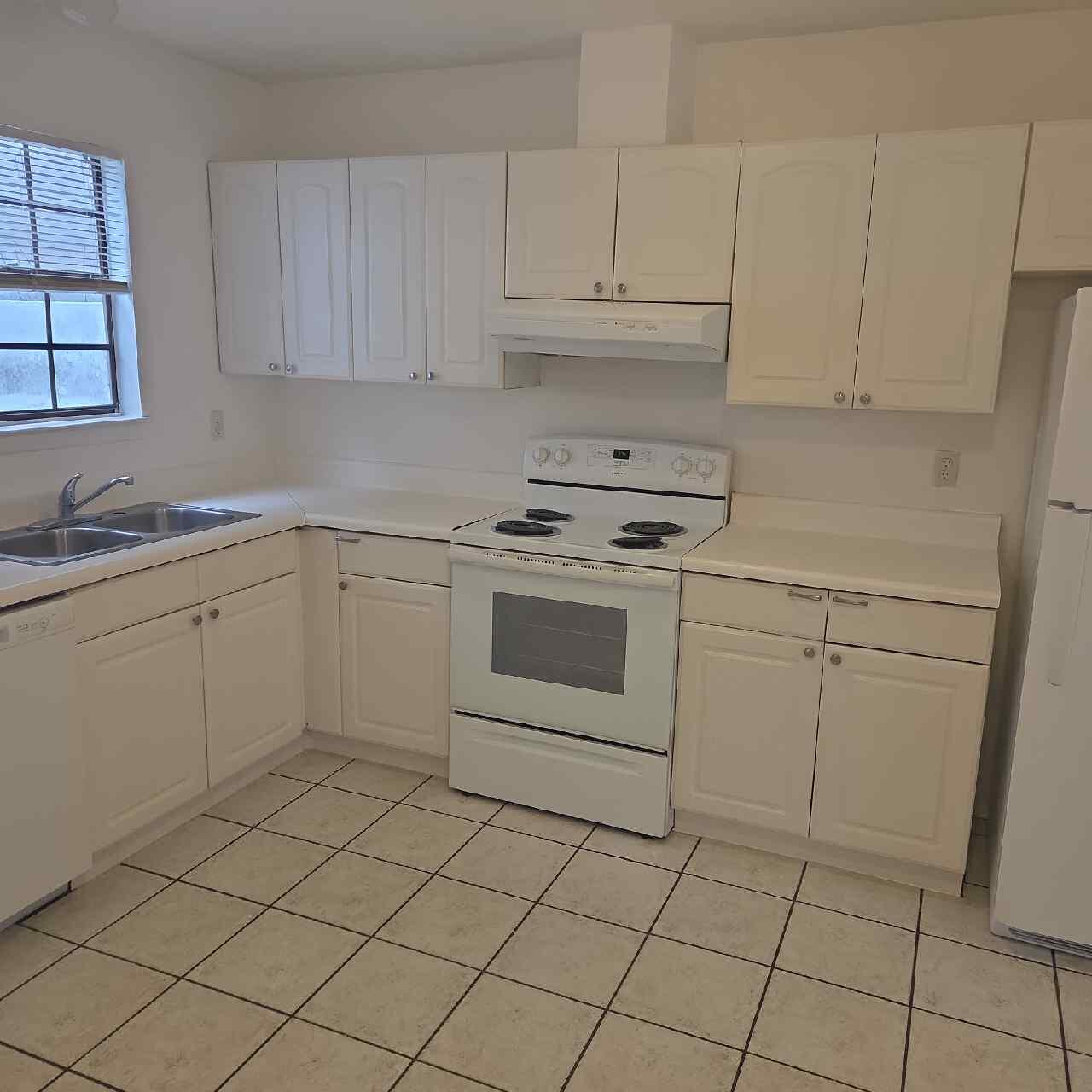 90 6th Avenue, Unit 4 Shalimar, FL 32579 - Photo 2 of 10 a kitchen with cabinets appliances and a sink