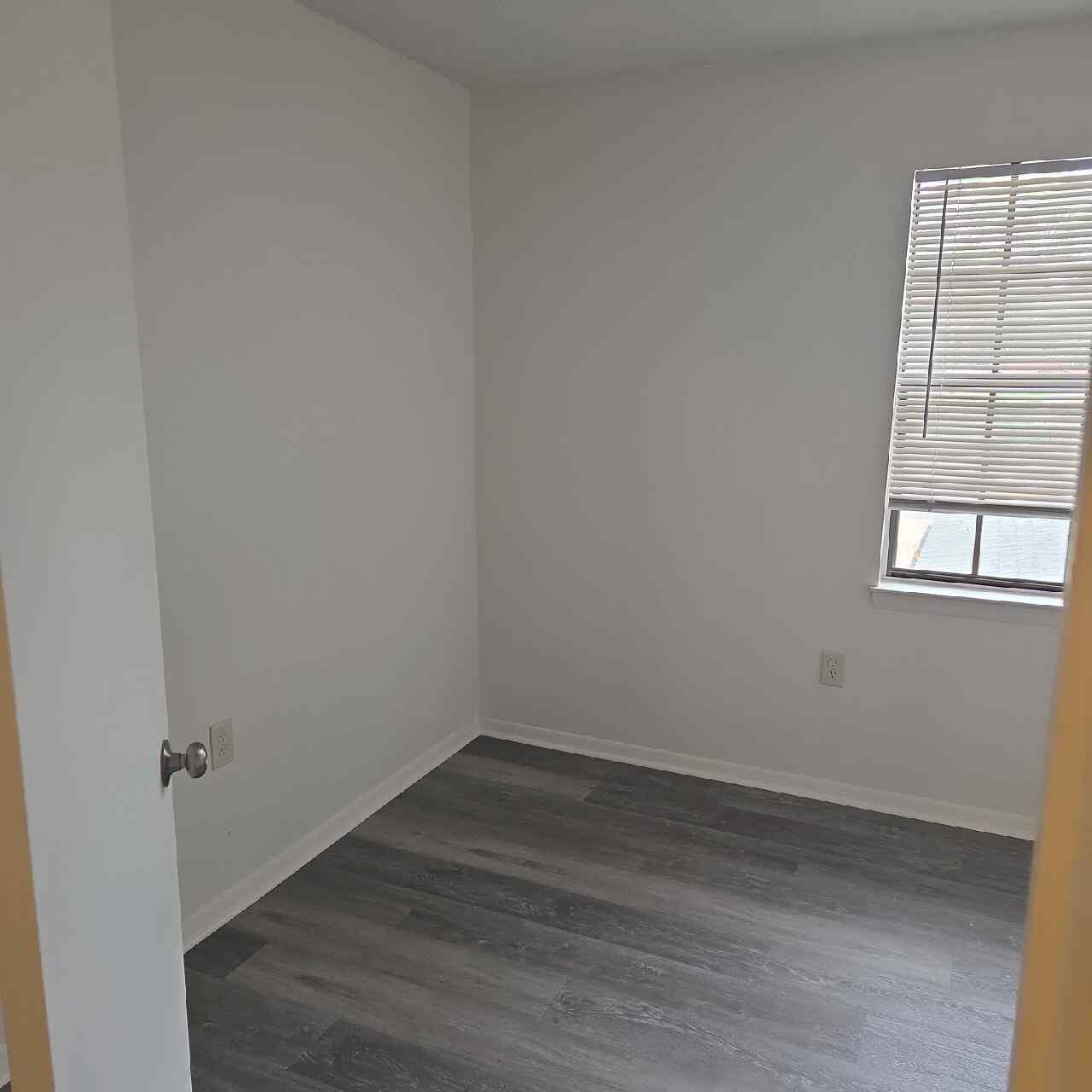 90 6th Avenue, Unit 4 Shalimar, FL 32579 - Photo 8 of 10 an empty room with wooden floor and windows