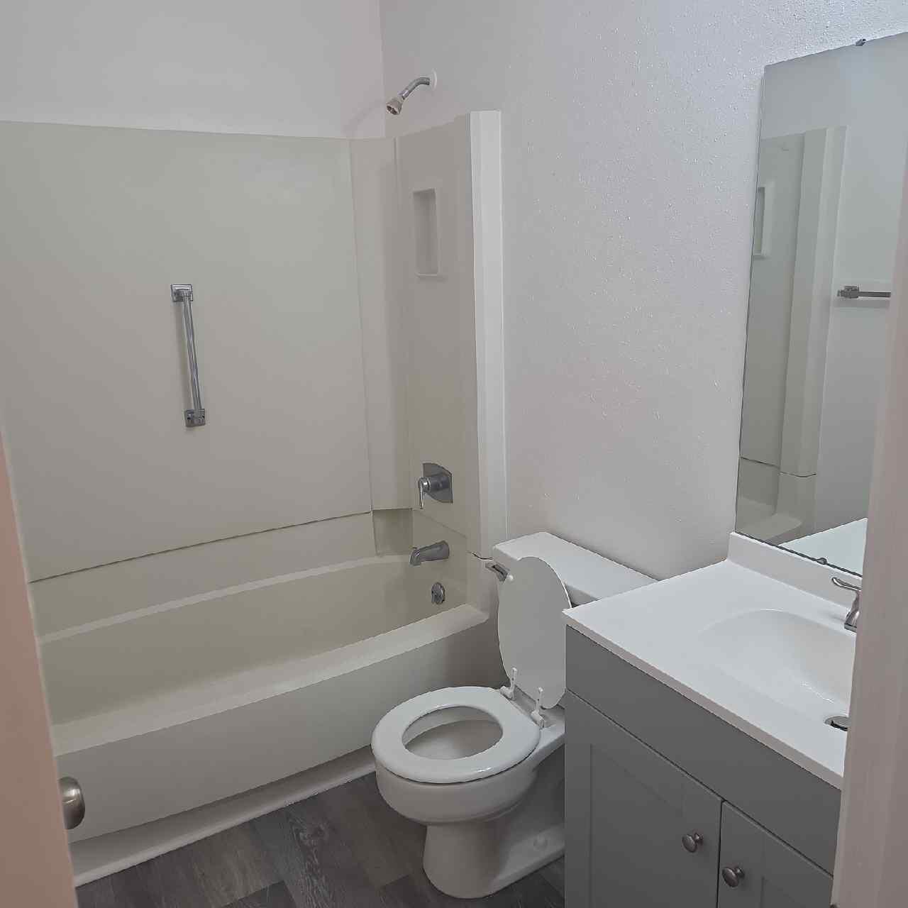 90 6th Avenue, Unit 4 Shalimar, FL 32579 - Photo 9 of 10 a bathroom with a sink a toilet and shower