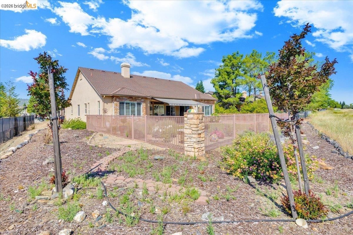 158 Rock Ridge Lane Copperopolis, CA 95228 - Photo 51 of 72 Rear exterior featuring a stucco finish, shingle roof, and a fenced patio area