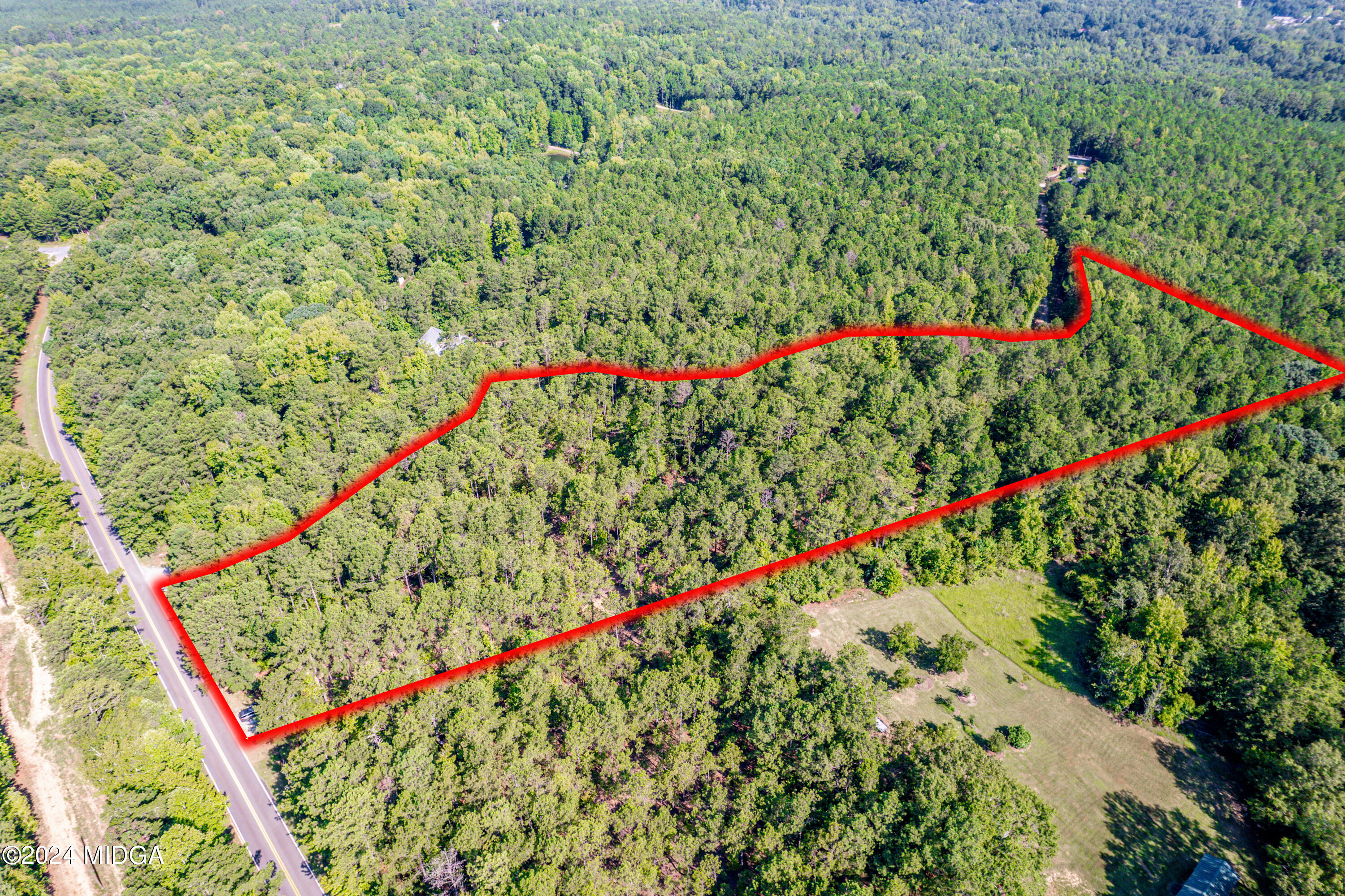 359 Bowen Hill Road Haddock, GA 31033 - Photo 13 of 16 a green field with flowers and trees