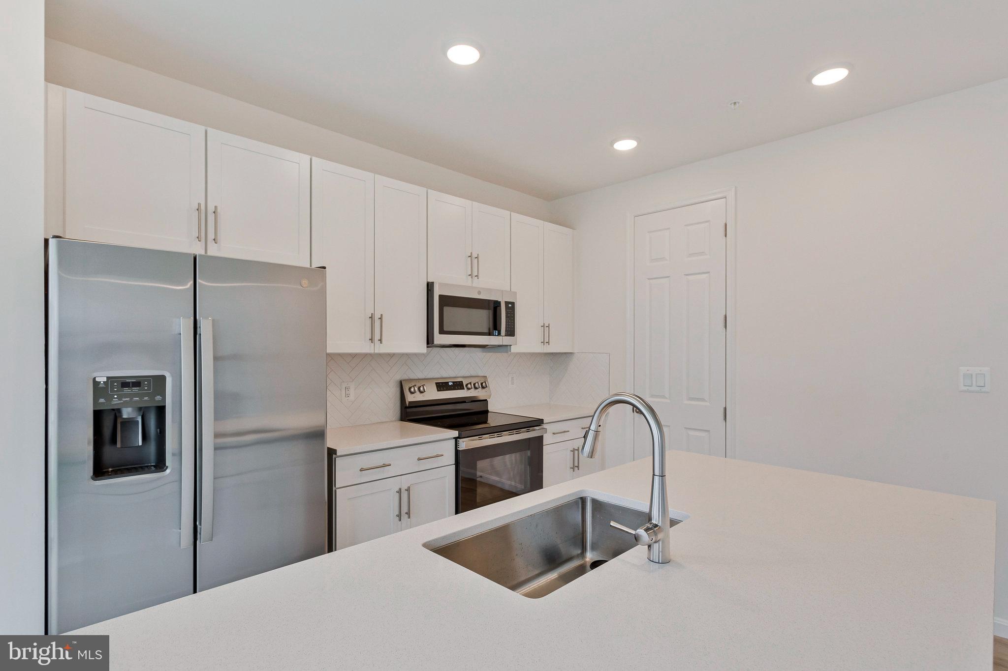 18 Poplar Court North East, MD 21901 - Photo 13 of 42 a kitchen with stainless steel appliances granite countertop a refrigerator a sink a stove and cabinets