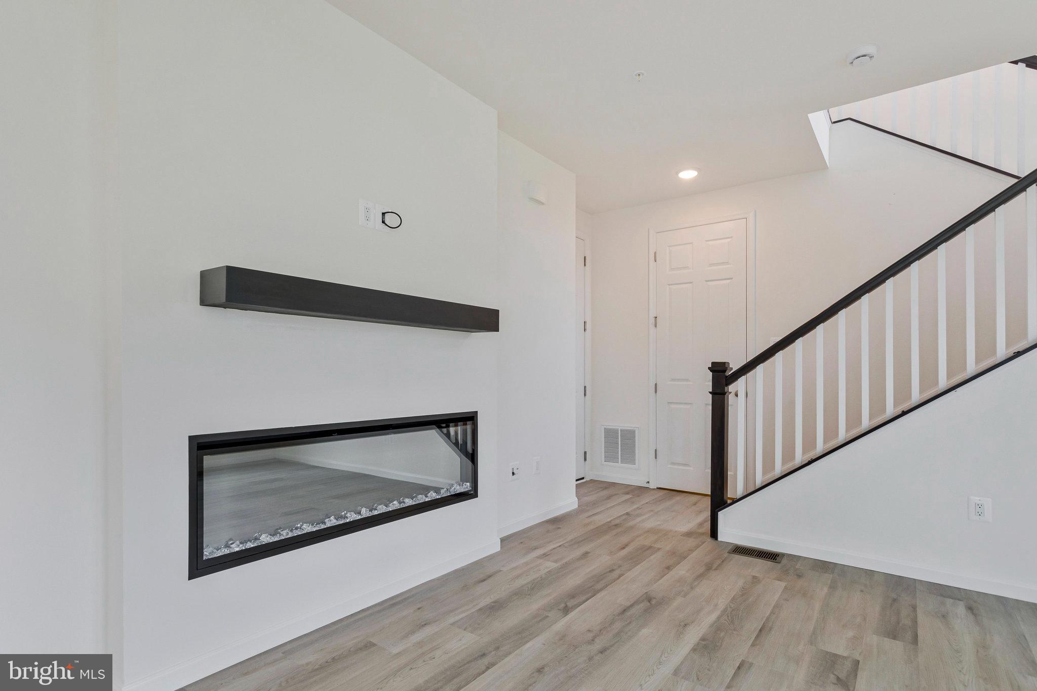 18 Poplar Court North East, MD 21901 - Photo 17 of 42 a view of an empty room with wooden floor and a fireplace