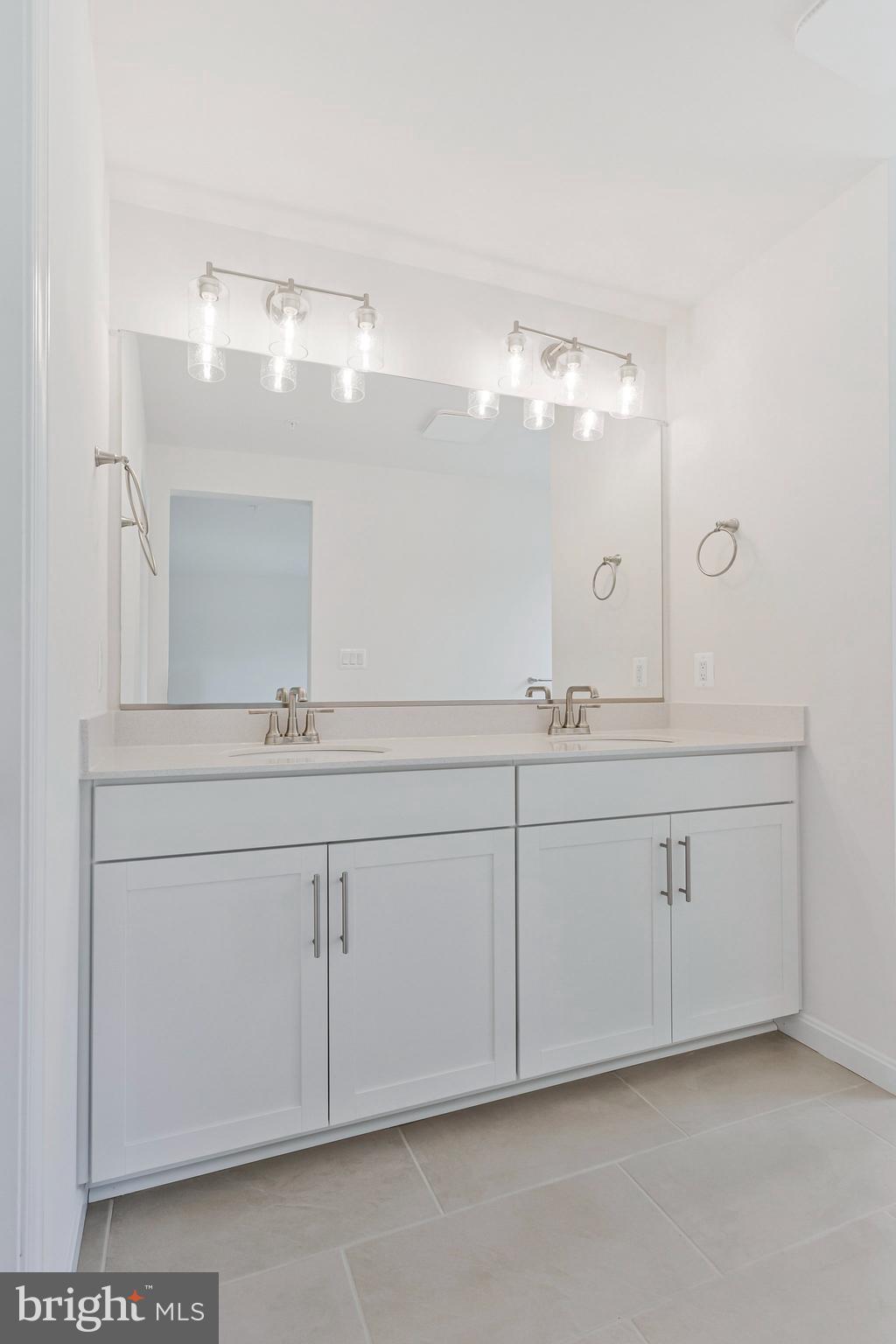 18 Poplar Court North East, MD 21901 - Photo 24 of 42 a bathroom with a double vanity sink and mirror