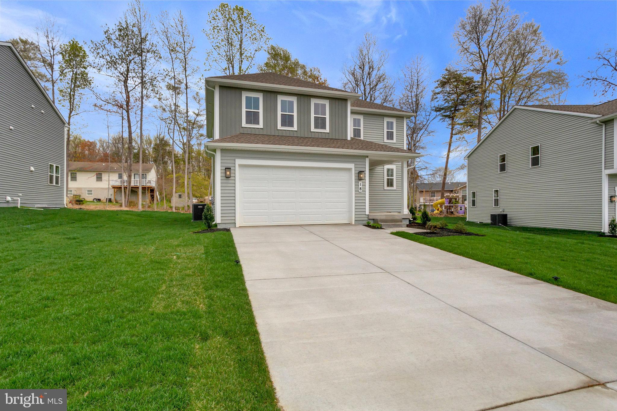 18 Poplar Court North East, MD 21901 - Photo 3 of 42 a front view of a house with a garden and yard