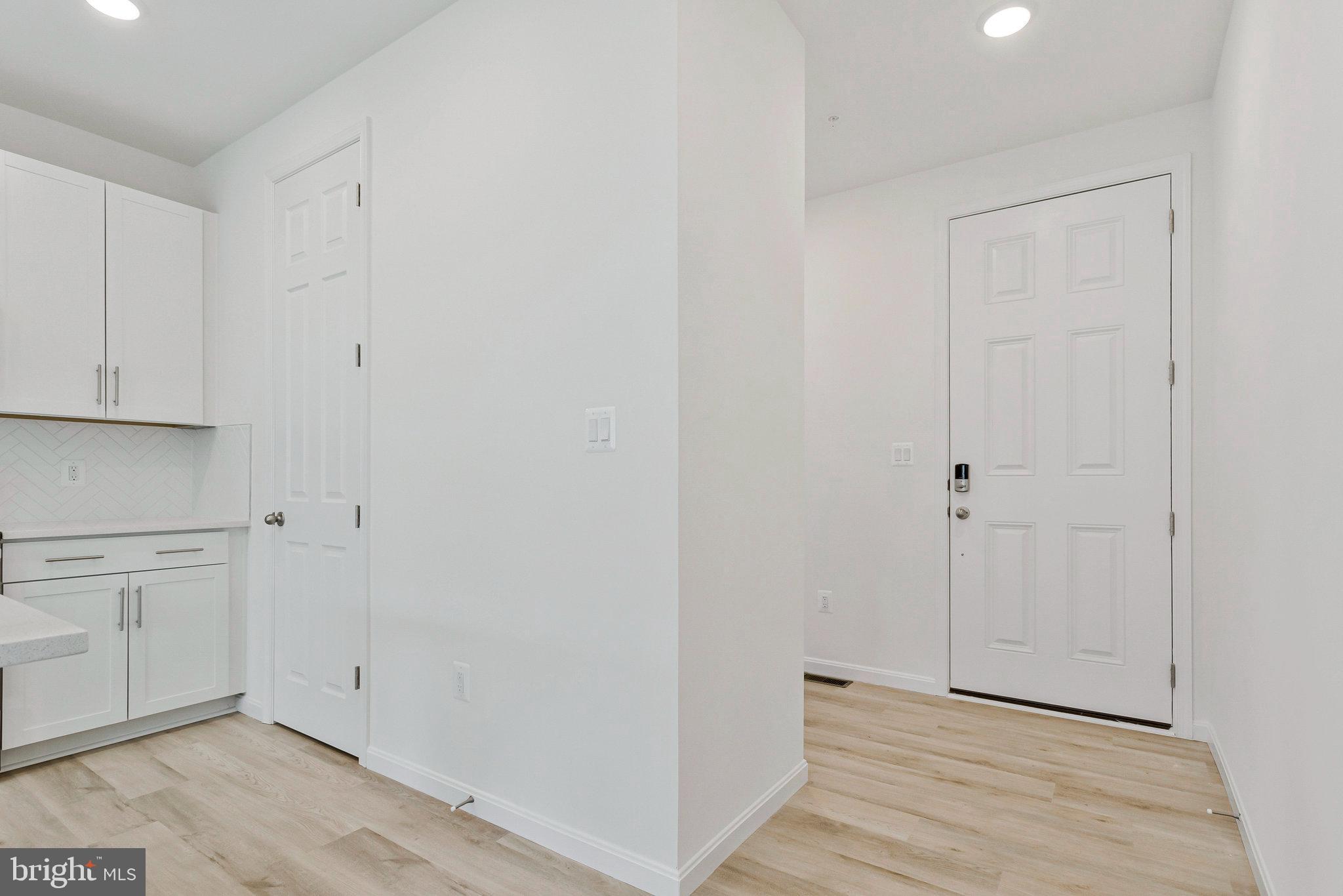 18 Poplar Court North East, MD 21901 - Photo 9 of 42 a view of a kitchen with white cabinets and wooden floor