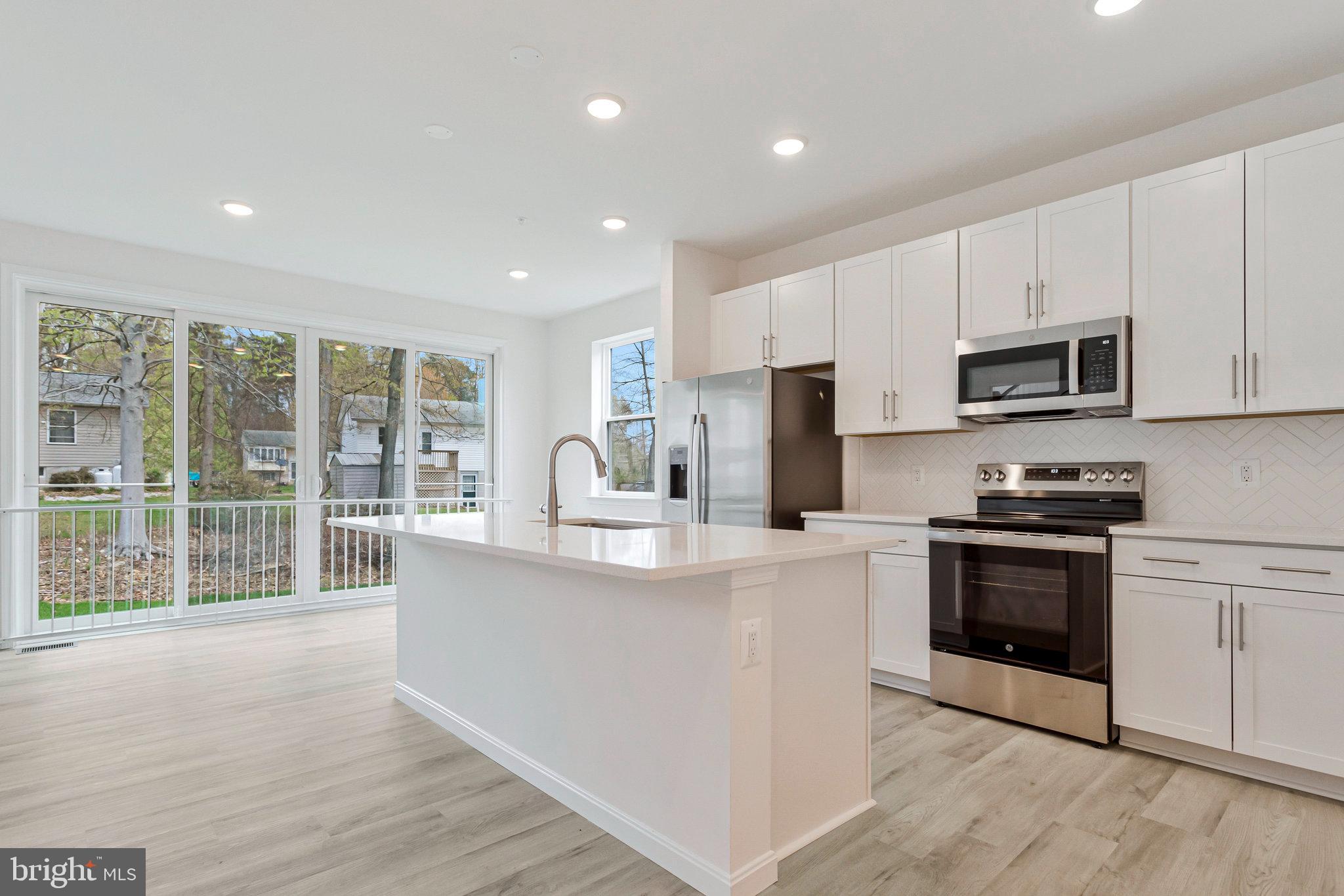 18 Poplar Court North East, MD 21901 - Photo 10 of 42 a kitchen with stainless steel appliances a stove top oven a sink a refrigerator a window