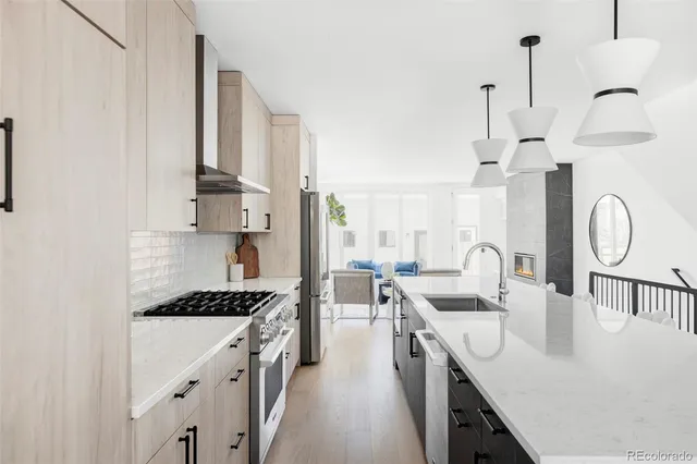 a kitchen with counter top space a sink a stove and refrigerator