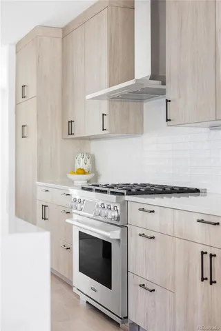 a kitchen with cabinets appliances and wooden floor