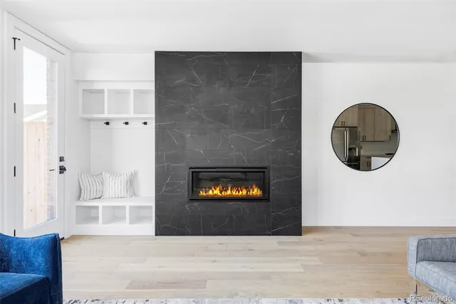 a view of a livingroom with wooden floor and a large window