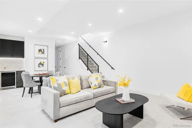 a living room with furniture and a lamp