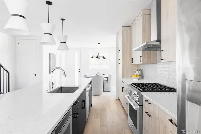 a kitchen with stainless steel appliances kitchen island a white counter space a sink and cabinets