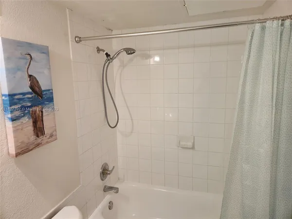 a bathroom with a shower and a bath tub