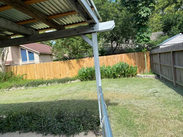 a view of a porch with a table chairs and a yard