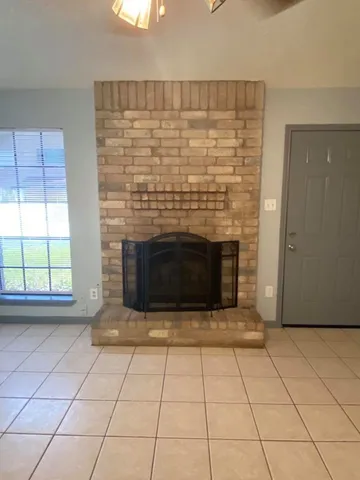 a kitchen with stainless steel appliances granite countertop a sink window and cabinets