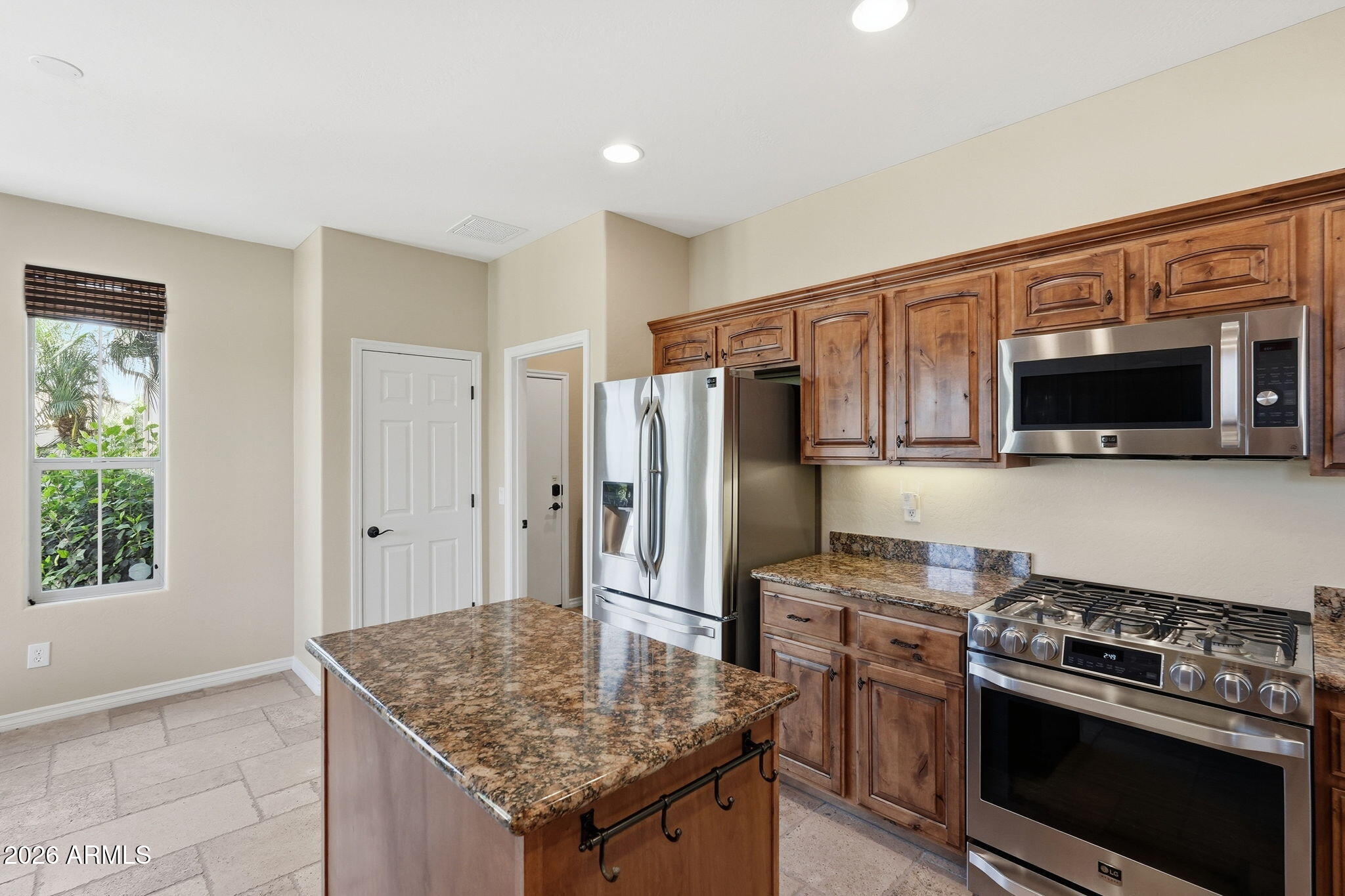 1694 East Grand Ridge Road Queen Creek, AZ 85140 - Photo 15 of 61 a kitchen with stainless steel appliances granite countertop a stove refrigerator and microwave
