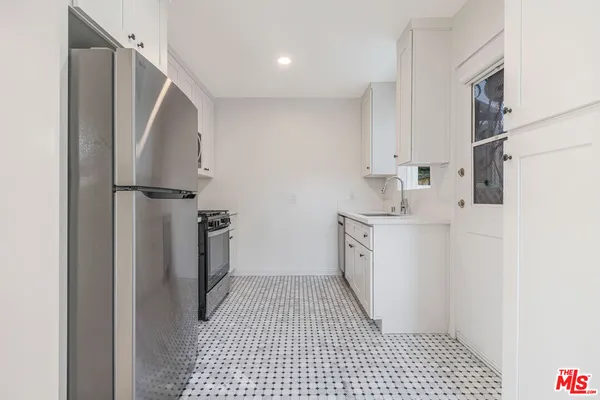 a bathroom with a sink a toilet and a shower