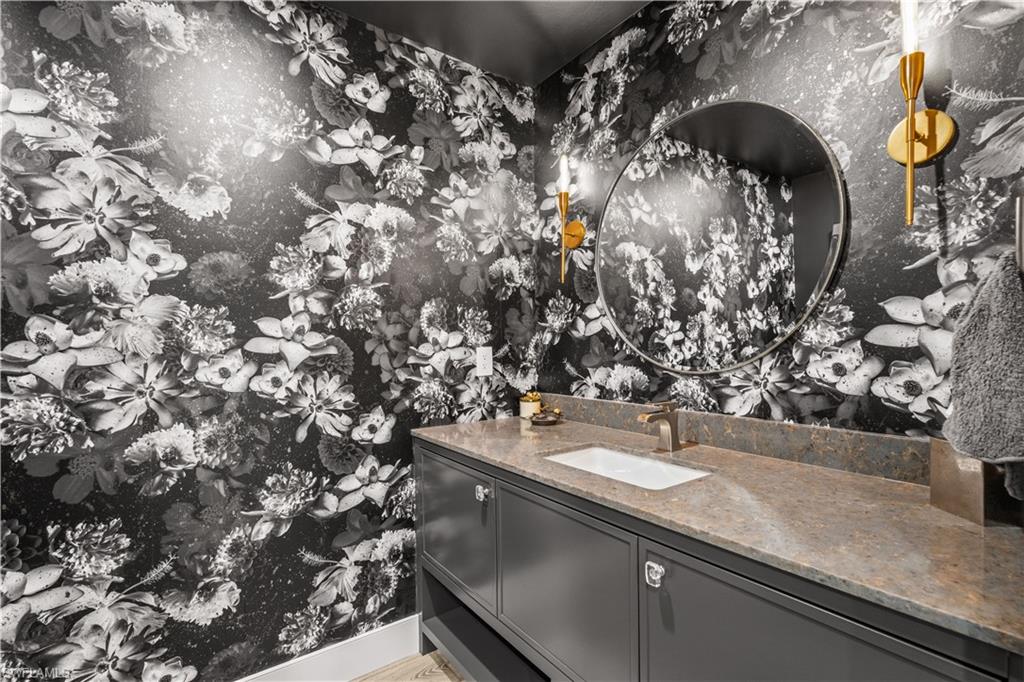 13925 Old Coast Road, Unit 1003 Naples, FL 34110 - Photo 16 of 33 Bathroom with vanity and wallpapered walls