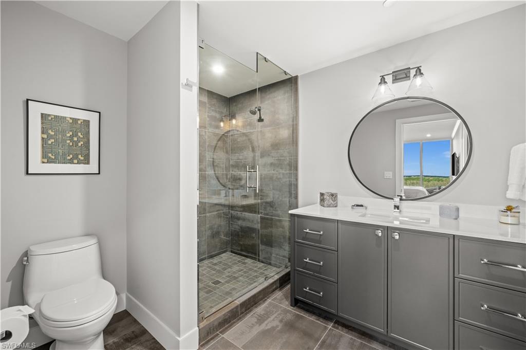 13925 Old Coast Road, Unit 1003 Naples, FL 34110 - Photo 20 of 33 Full bath with vanity and a shower stall