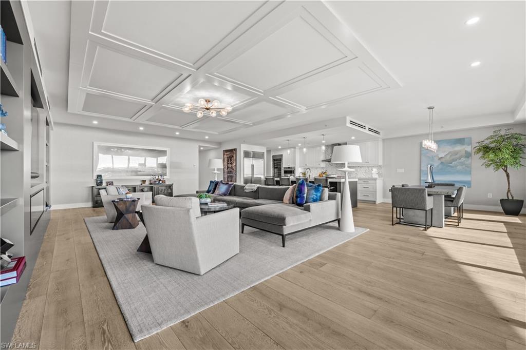 13925 Old Coast Road, Unit 1003 Naples, FL 34110 - Photo 5 of 33 Living room with suspended lighting, light wood-type flooring, and coffered ceiling