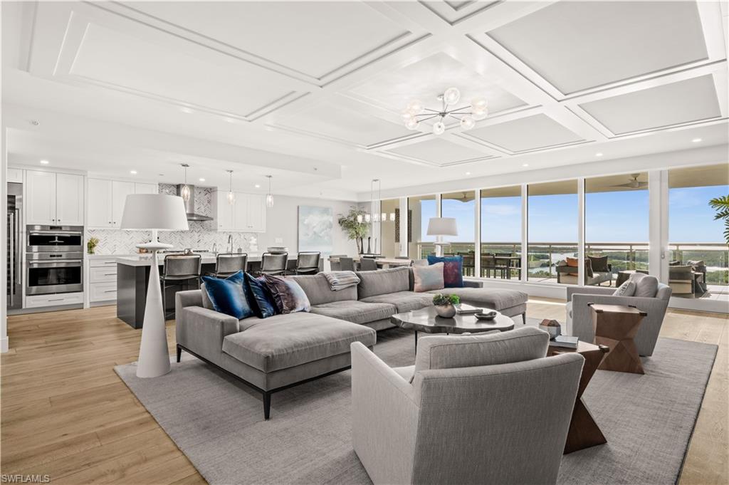 13925 Old Coast Road, Unit 1003 Naples, FL 34110 - Photo 6 of 33 Living area with suspended lighting, coffered ceiling, and light wood-type flooring