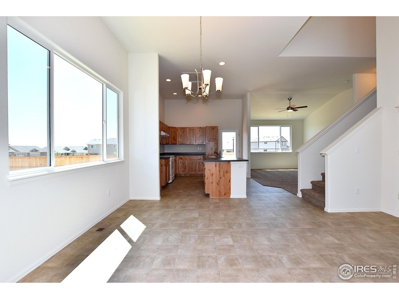 2304 Sublime Drive Windsor, CO 80550 - Photo 12 of 39 a view of a kitchen with a dishwasher cabinets and a large window