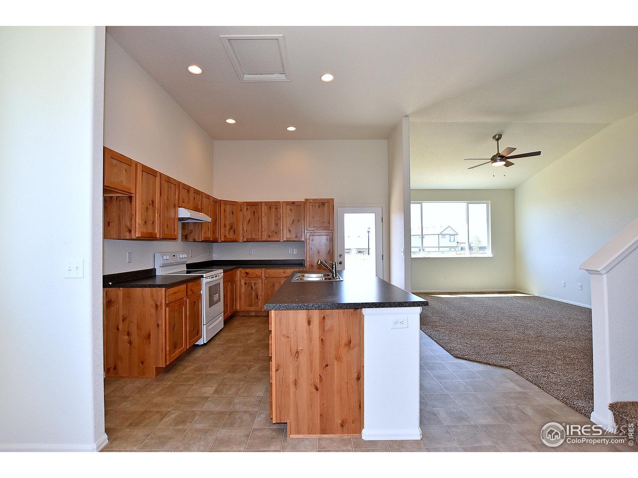 2304 Sublime Drive Windsor, CO 80550 - Photo 21 of 39 a living room with stainless steel appliances kitchen island granite countertop furniture and a large window