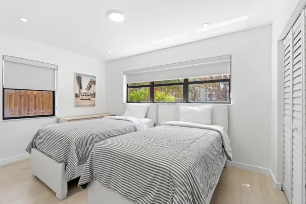 a bedroom with a large bed and a window