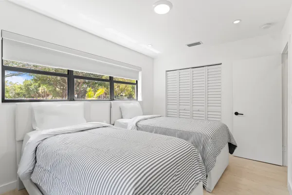 a bedroom with a large bed and a window