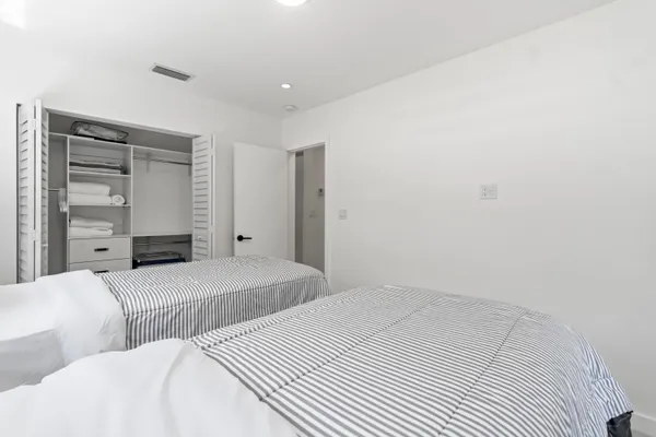 a bedroom with a bed and cabinet