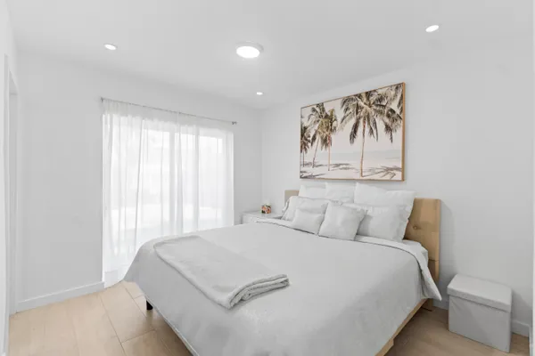 a bedroom with a large bed and a window